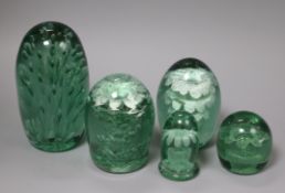 A collection of five green glass dumps, boxed