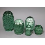 A collection of five green glass dumps, boxed