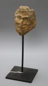 A Folk Art stone carving of head on stand