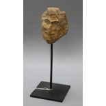 A Folk Art stone carving of head on stand