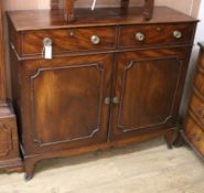 A Regency mahogany cupboard, fitted with a pair of drawers over two doors W.114cm