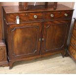 A Regency mahogany cupboard, fitted with a pair of drawers over two doors W.114cm