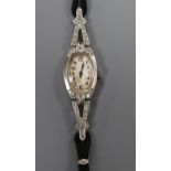 A lady's Art Deco platinum and diamond-set cocktail watch, having Arabic dial, on black cord