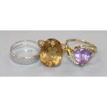 A 9ct gold and citrine dress ring, a 9ct white gold band and a yellow metal and amethyst ring.