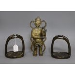 A Chinese bronze figure of a boy and a pair of early Chinese bronze stirrups