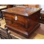 An early Victorian flame mahogany sarcophagus shaped wine cooler, with rectangular top enclosing a