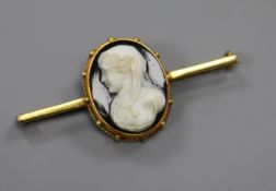 An early 20th century yellow metal and hardstone cameo bar brooch, 49mm.