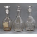 Three large glass decanters and stoppers height 37cm