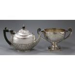 An Edwardain demi-fluted silver teapot and a later two handled silver trophy cup, gross 22 oz.