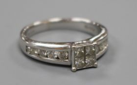 A modern 18ct white gold and princess cut diamond cluster ring with diamond set shoulders, total