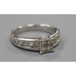 A modern 18ct white gold and princess cut diamond cluster ring with diamond set shoulders, total