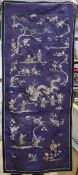 A Chinese silk embroidered panel, worked with figures, dragons and peonies, on a purple ground