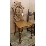 A Victorian oak hall chair