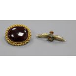 A Victorian yellow metal and cabochon garnet set oval brooch and a later 9ct gold and enamel