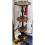 A late Victorian mahogany three tier dumb waiter, on turned partly reeded support, on scrolled