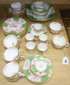 A quantity of Minton and Coalport green and gilt teaware