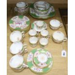 A quantity of Minton and Coalport green and gilt teaware