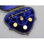 Three 18ct gold dress studs, a stick pin and an 18ct gold and diamond set dress stud.