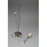 Three hat pins, a silver mounted hatpin holder, pair of silver wishbone sugar nips and a silver