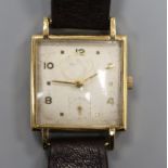 A gentleman's stylish 9ct gold Baume square cased manual wind wrist watch.