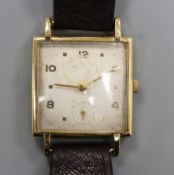 A gentleman's stylish 9ct gold Baume square cased manual wind wrist watch.