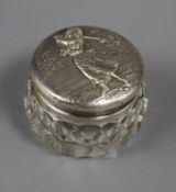 A sterling silver mounted glass toilet jar, the lid embossed with a lady golfer, 55mm.