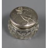 A sterling silver mounted glass toilet jar, the lid embossed with a lady golfer, 55mm.