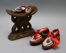 A pair of beaded North American Indian childs moccasins, a similar miniature pair and a tribal