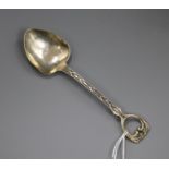 An Edwardian Arts and Crafts silver preserve spoon by Albert Edward Jones, Birmingham 1906, 15.6cm.