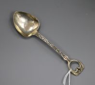 An Edwardian Arts and Crafts silver preserve spoon by Albert Edward Jones, Birmingham 1906, 15.6cm.