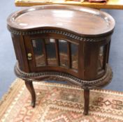 A reproduction kidney-shaped glazed tray-top cabinet W.76cm