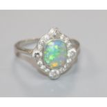 A 1920's white metal, black opal and diamond cluster ring, size P.