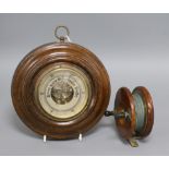 A J. Marshall fishing reel and an aneroid barometer