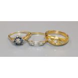 Three assorted 18ct gold and gem set rings including diamond.