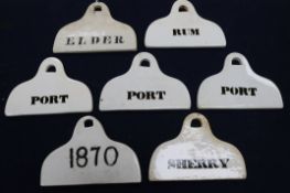 Seven 19th century creamware pyriform bin labels, arched suspension holes unmarked