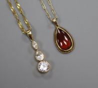 A 9ct gold and garnet tear-drop pendant on 9ct gold chain and a similar three-stone cubic zirconia