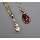 A 9ct gold and garnet tear-drop pendant on 9ct gold chain and a similar three-stone cubic zirconia