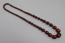 A single strand simulated cherry amber necklace, gross 76 grams, 72cm.