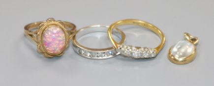 Two 18ct gold and diamond rings, a 9ct gold ring and a moonstone pendant.