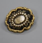 An early Victorian yellow metal, black enamel and seed pearl set mourning brooch, 26mm.
