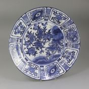 A Japanese Arita blue and white dish, c.1680-1700, the centre painted in Kraak style with geese amid