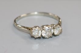 An 18ct white gold and platinum three stone diamond ring, size P.