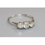 An 18ct white gold and platinum three stone diamond ring, size P.