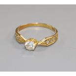 An early 20th century 18ct gold and single stone diamond ring, with diamond set shoulders, size K.