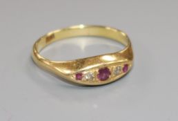 An 18ct gold, small five stone ruby and diamond ring, size Q/R.