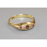 An 18ct gold, small five stone ruby and diamond ring, size Q/R.