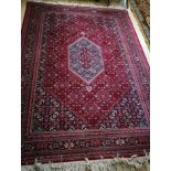 A Persian red ground rug 235 x 170cm