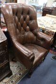 A Victorian simulated rosewood armchair covered in buttoned hide