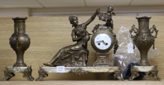 A late 19th century French gilt spelter figural three piece clock garniture, the eight day oak clock