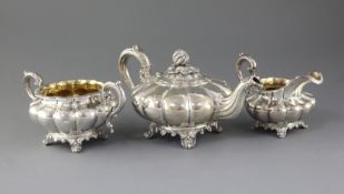 A William IV three piece silver melon shaped tea set, A.B. Savory & Sons, with pumpkin finial, on